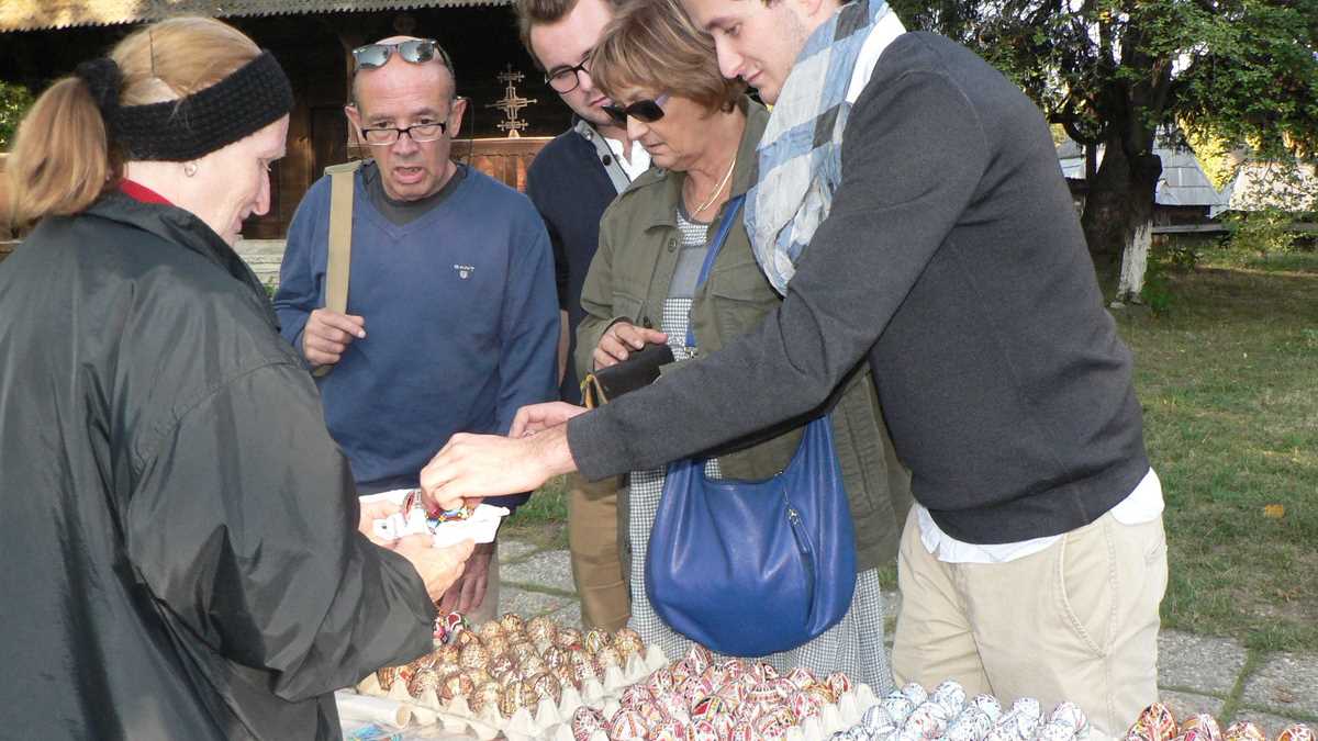 Turiști francezi cumpărînd ouă încondeiate la Muzeul Satului. FOTO: Alexandra Ionescu